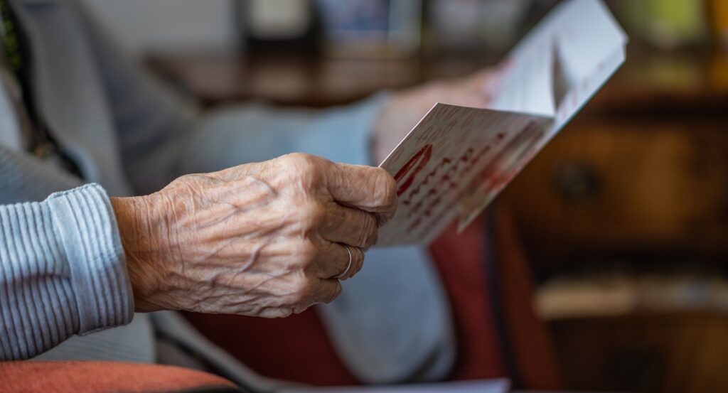 Elderly resident viewing a greeting card
